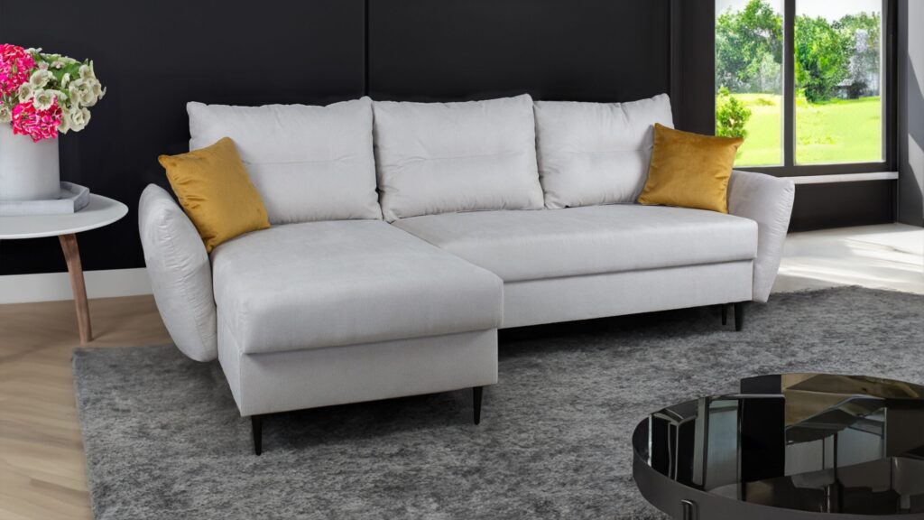 Narożnik rozkładany Aura z funkcją spania i pojemnikami na pościel w nowoczesnym wnętrzu