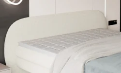 Łóżko tapicerowane Ovo 140x200 z zaokrąglonym wezgłowiem i metalowymi nóżkami w nowoczesnym wnętrzu