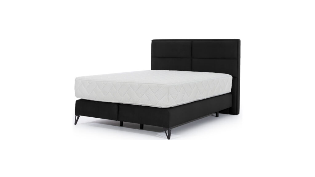 Łóżko kontynentalne Safiro 140x200 z wysokim pikowanym zagłówkiem i czarnymi nóżkami na tle jasnej sypialni