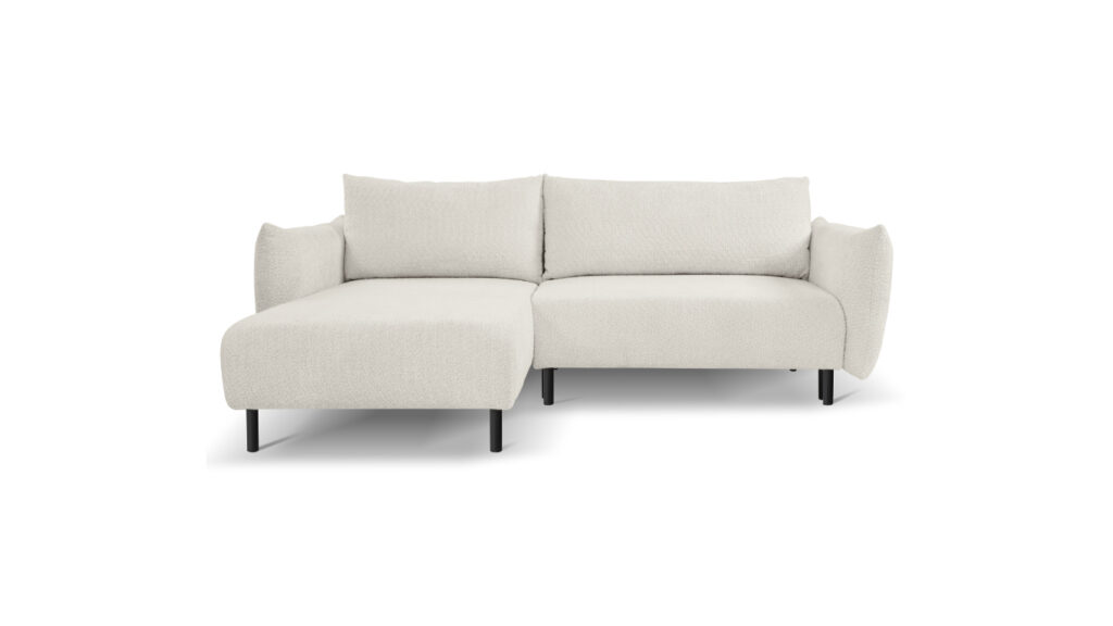 Narożnik rozkładany Adel z dużymi poduszkami i czarnymi metalowymi nogami w nowoczesnym wnętrzu