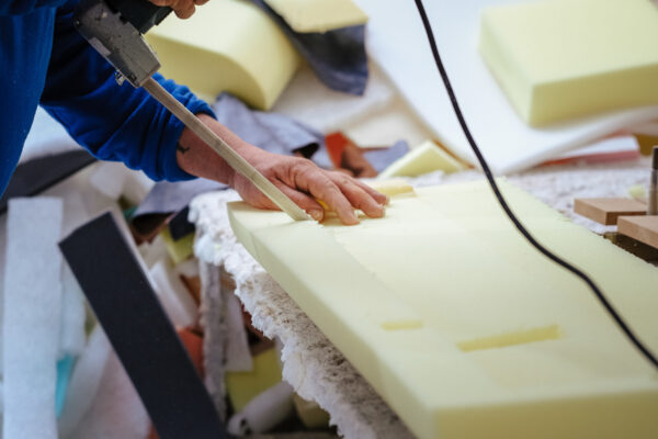 A closeup shot of a male working in a furniture factory